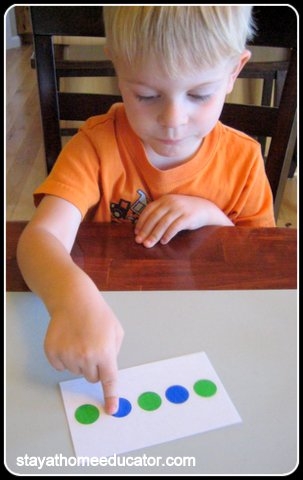 preschool boy using color pattern cards