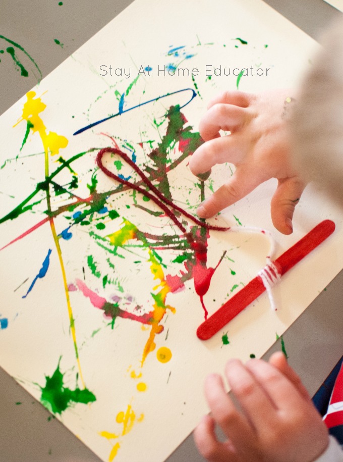 pressing the yarn onto the paper - yarn paintings or string painting for kids - this is a process art activity for toddlers and preschoolers