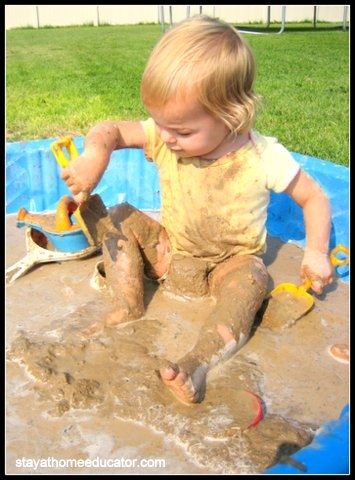 Fun preschool play in the mud with a small swimming pool.