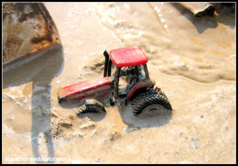 Tractors love to play in the mud too. Fun preschool play.