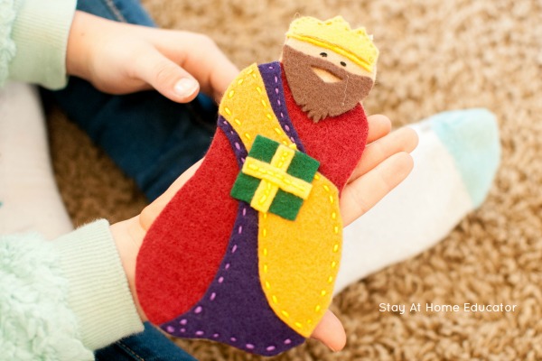 Child holding wise man from felt nativity