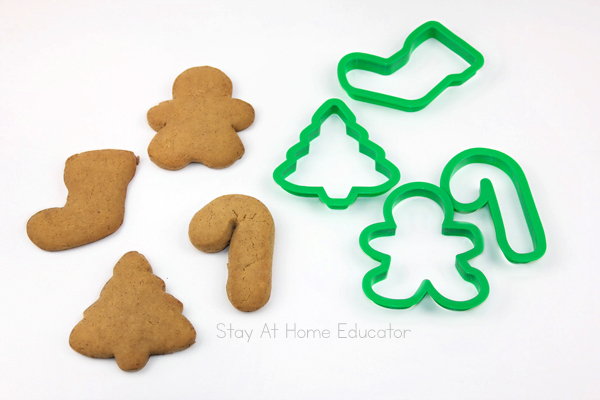 gingerbread playdough recipe that is edible |  gingerbread scented playdough cut out with cookie cutters, a gingerbread man, Christmas tree, stocking and candy cane