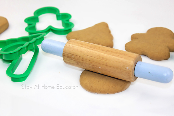 edible gingerbread playdough recipe |  gingerbread scented playdough cut out with cookie cutters and a small, child size rolling pin