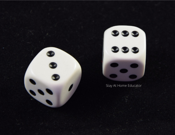 two dice on a black background showing subitizing the numbers three and six