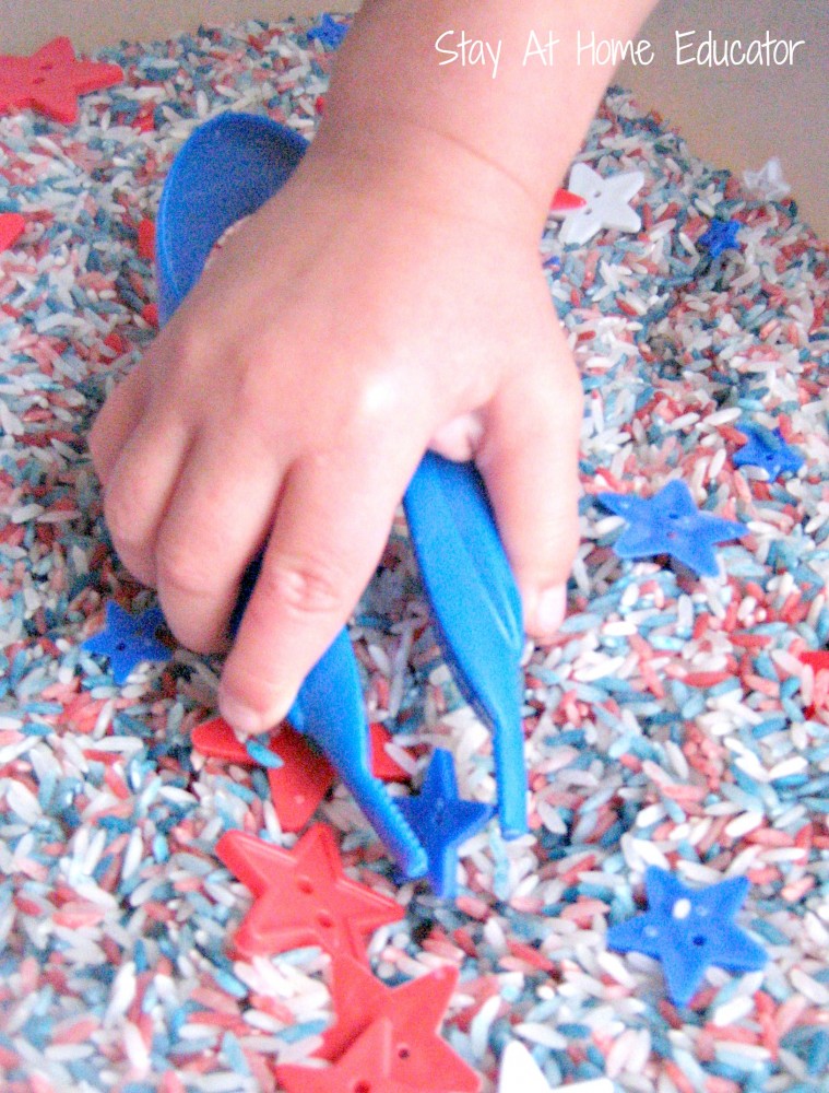 tweezing star buttons in Fourth of July sensory bin - Stay At Home Educator