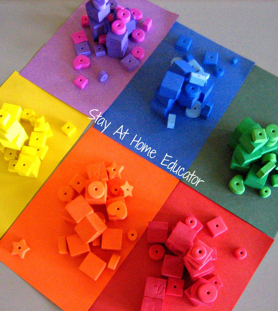 Sorting foam pieces by color using jumbo tweezers for a preschool fine motor activity - Stay At Home Educator