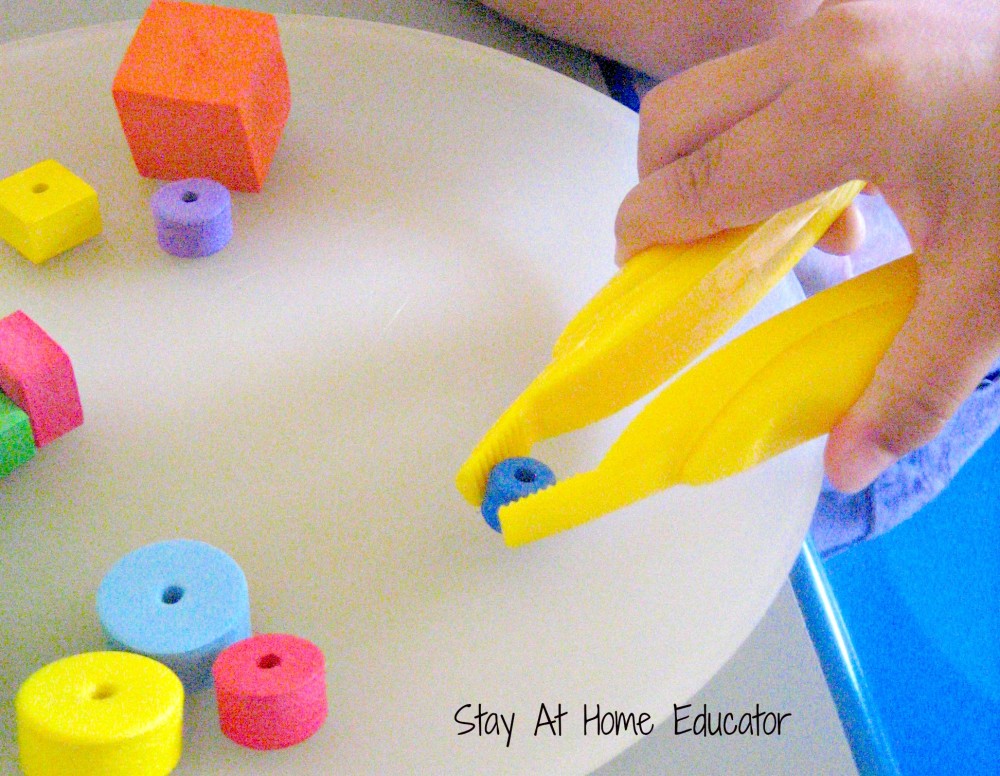 Tweezing foam pieces for fine motor color sorting activity - Stay At Home Educator