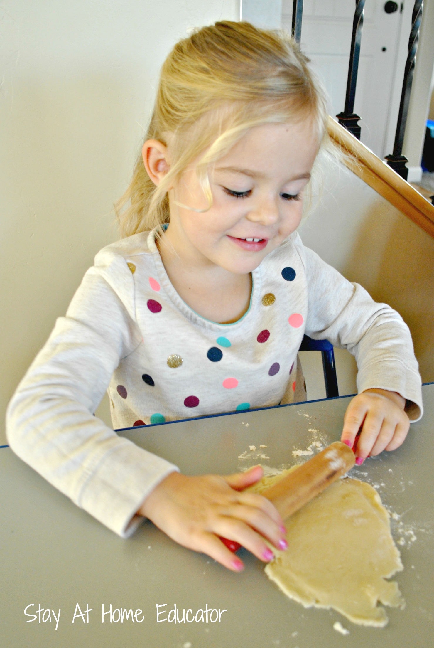 Preschooler rolling out pie dough for mini apple pies - Stay At Home Educator