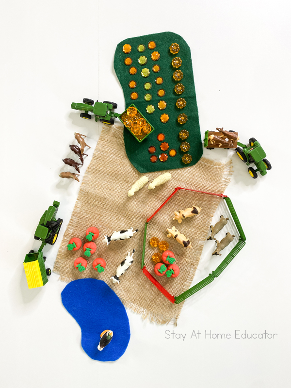 Farm themed objects make a small world play area | farm animals, toy fence, acrylic pumpkins | small world farm play |