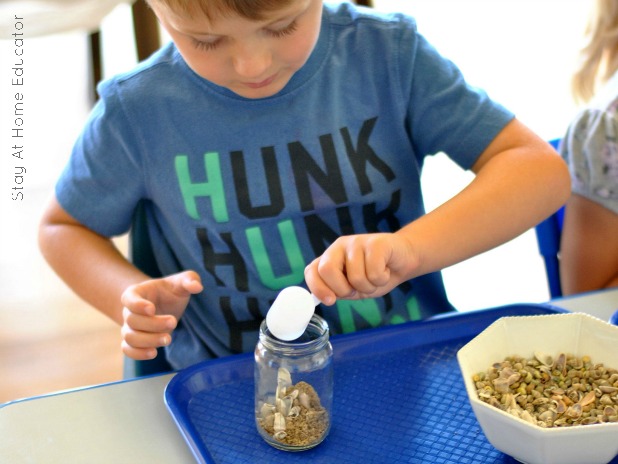 Filling an ocean discovery bottle with seashells is also a scooping and pouring activity that develops fine motor skills.