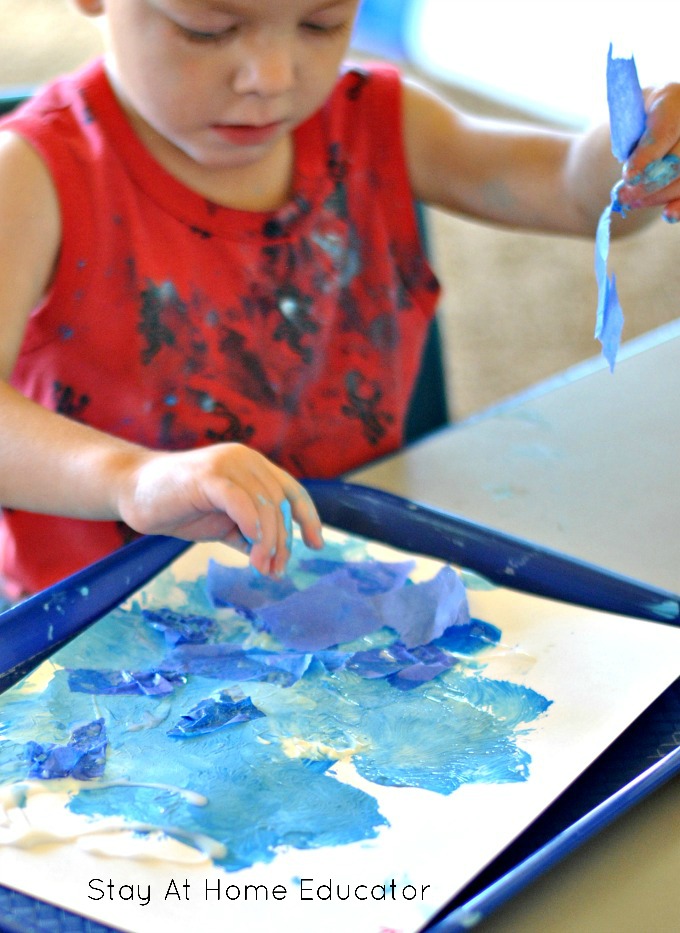 Sand, tissue paper, blue paint and star cut-outs to make ocean art, a process art in preschool, great for toddlers, too