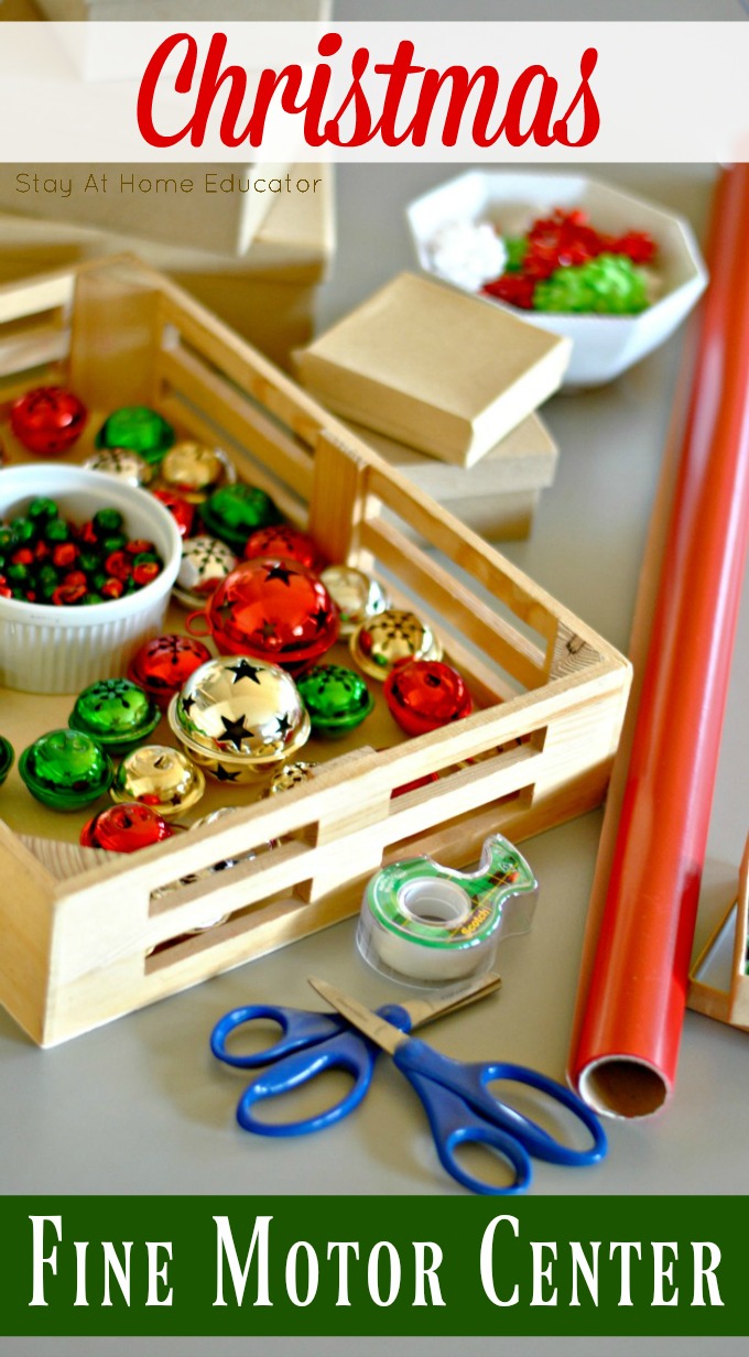 Christmas fine motor center for preschoolers where preschoolers wrap pretend gifts for the holidays | picture of a wooden basket filled with jingle bells. Next to it is a roll of red wrapping paper, tape, and two pairs of scissors.