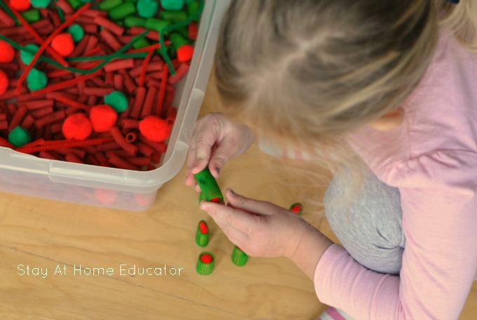Red and green Christmas sensory bin for toddlers and preschoolers.3