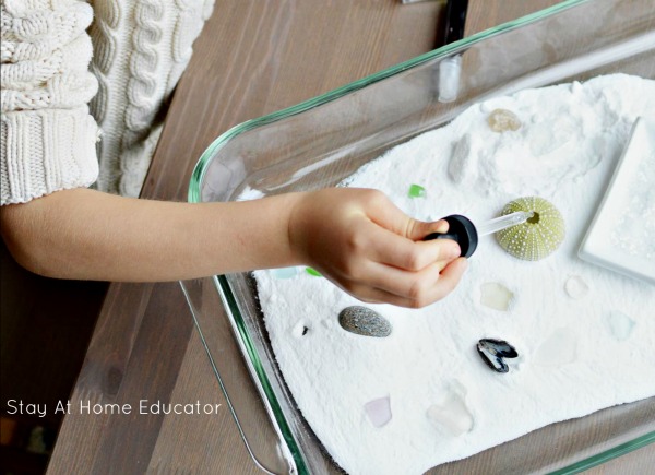 preschoolers playing in baking soda and vinegar ocean sensory bin for ocean sensory play for preschoolers
