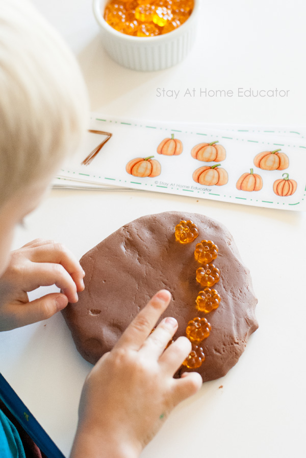 Explore early math skills with playdough and pumpkin counting cards