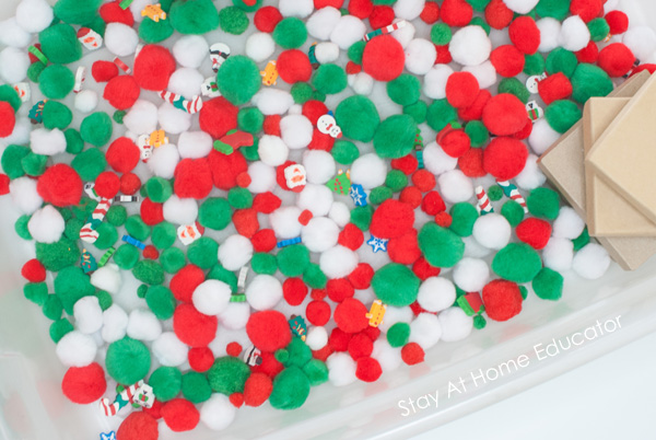 Christmas sensory bin for preschoolers with pom poms and erasers