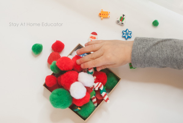 Playing with Christmas sensory bin for preschoolers