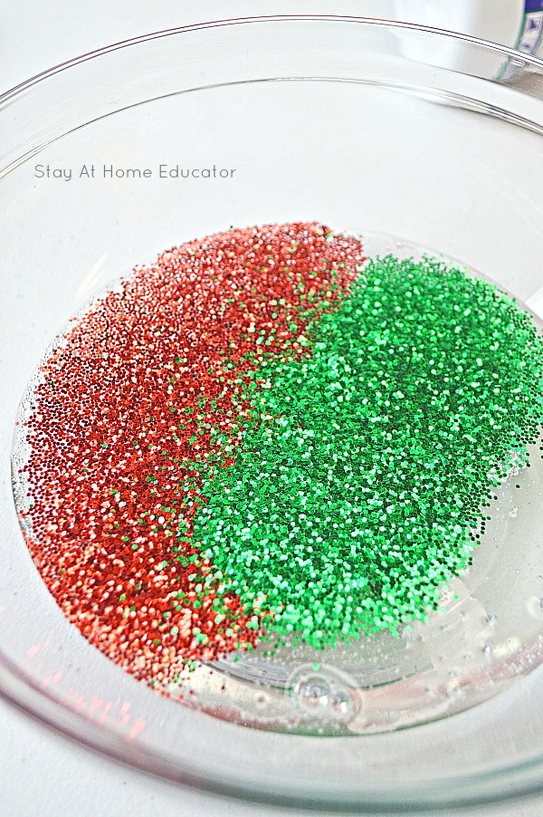 red and green glitter have been added to the bowl with the Christmas slime ingredients