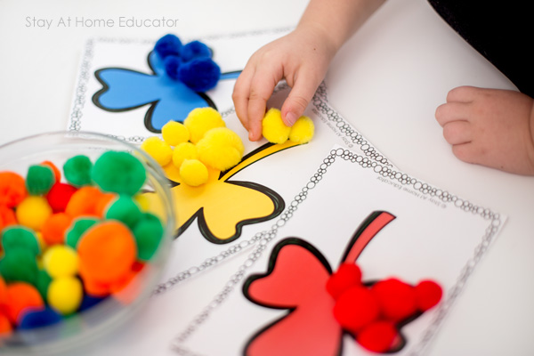 child using shamrock mats for color sorting printable activities