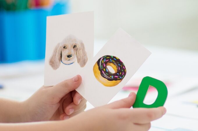 how to teach letter recognition to preschoolers - the importance of teaching letter recognition - child holding letter D flashcards