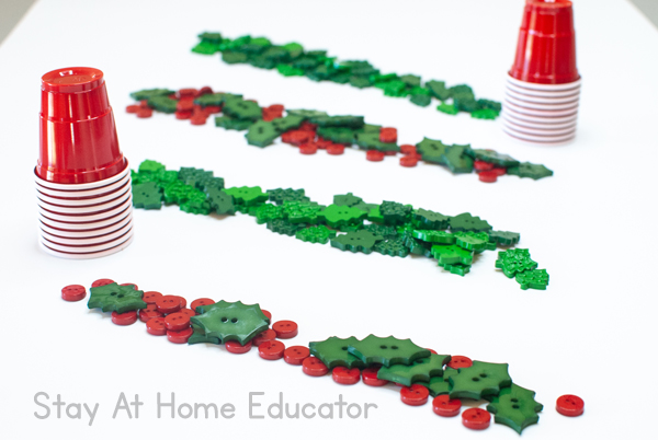 buttons in rows and red cups is a simple preschool invitation to play