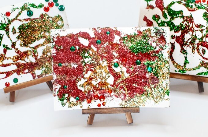 Christmas process art for preschoolers | sparkly christmas art canvas on display | preschool Christmas art projects |