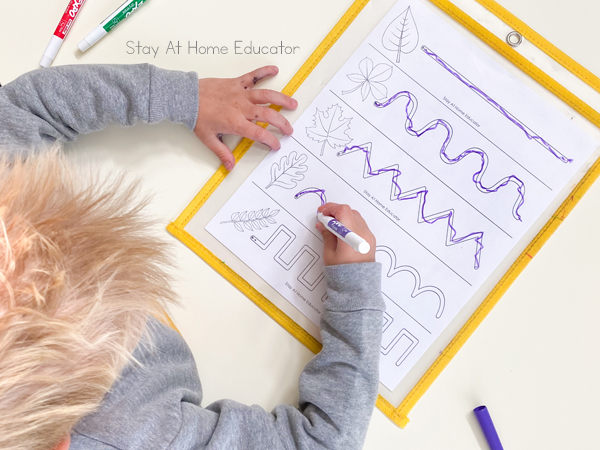 pre writing activities | prewriting worksheets | prewriting strokes | activities to teach preschool writing | preschool fall theme | fall leaves preschool activities little boy using dry erase marker to trace lines