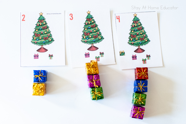 
Free Christmas Counting Cards for Preschool| Image shows Christmas tree cards lined up in order 2,3,4| A matching number of mini gifts is shown under each counting card|
