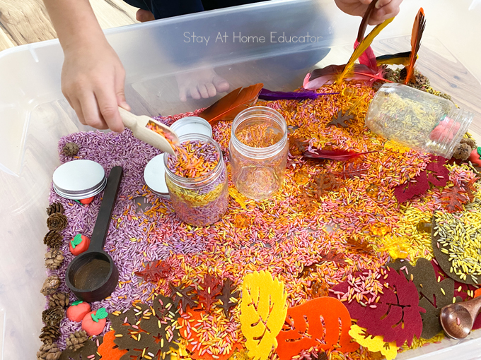 scooping and pouring activity for toddlers | benefits of scooping and pouring activities for toddlers | fine motor skills for toddlers | beautiful fall sensory bin for preschoolers with child scooping and pouring rice 