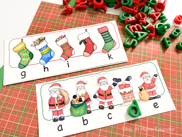 a child has filled in the missing letter d on a printable alphabet order card that's Christmas themed