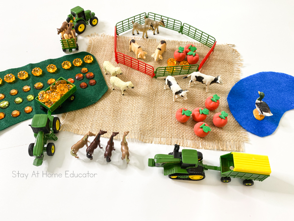 Farm small world setup | farm animals, toy tractor, acrylic pumpkins, and farm fence | farm small world | small world play preschool |