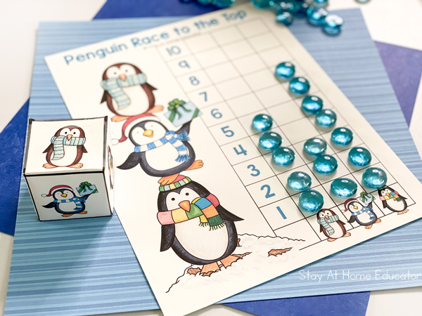 the process of winter math activities for preschool with a penguin graph in play
