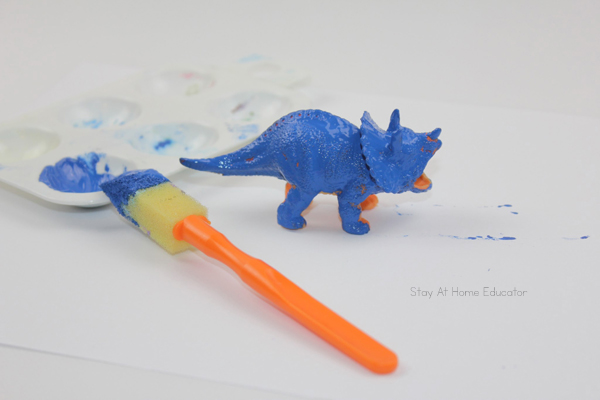 a toddler has completely painted this dinosaur blue