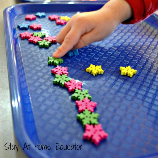 red and green snowflakes lined up in an AB pattern as part of pattern activities for preschool