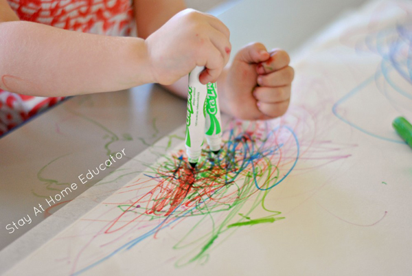 toddler explores using markers in big scribbling art for toddlers