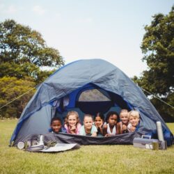 a group of kids participating in camping through the use of free camping preschool lesson plans and activities