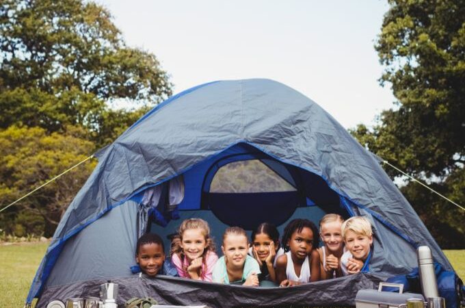 a group of kids participating in camping through the use of free camping preschool lesson plans and activities