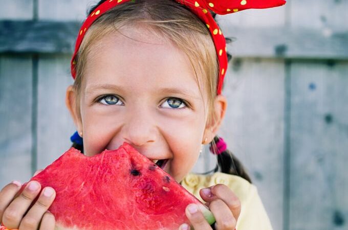 a child eating watermelon during her free preschool watermelon lesson plan activities