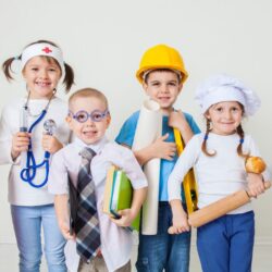 young children dressed as community helpers while using the free community helpers preschool lesson plans