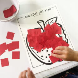child gluing red construction paper to an apple with glue dots | gluing practice for preschool | back to school fine motor |