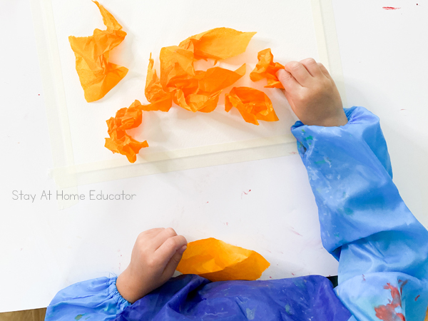 fall art ideas |toddler process art ideas | toddler fall activities | fall process art for preschoolers | toddler adding crumped tissue paper to artwork