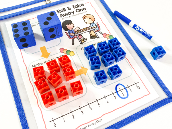 This addition and subtraction math center uses snap cubes to help preschoolers practice adding or taking one from a given number. This math center is included in our addition and subtraction daily lessons in math unit.
