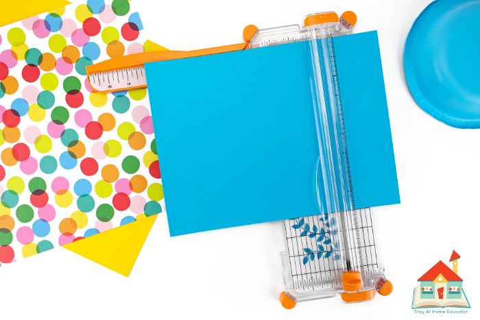use a large paper cutter to cut the poster board down to size for preschool graduation caps