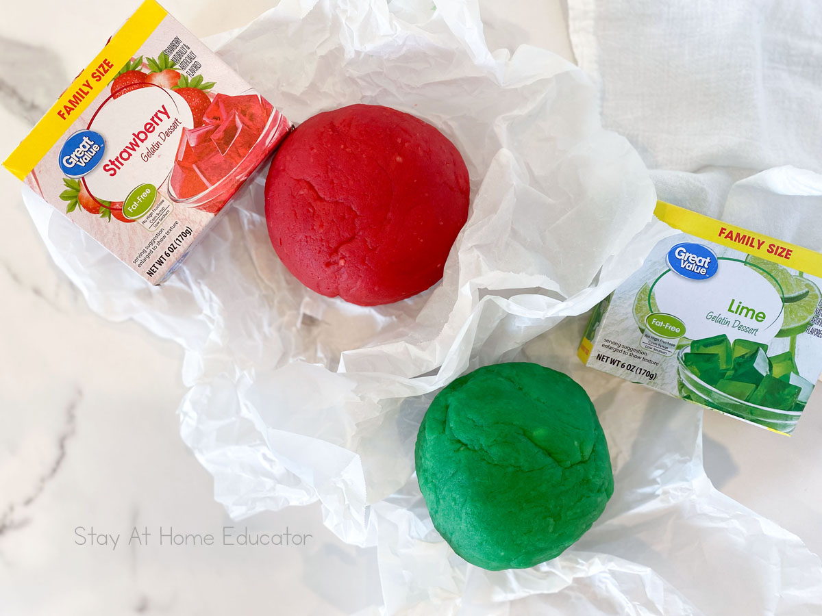 jello playdough recipe | red and green playdough on parchment paper with flavored gelatin | easy recipe for jello playdough