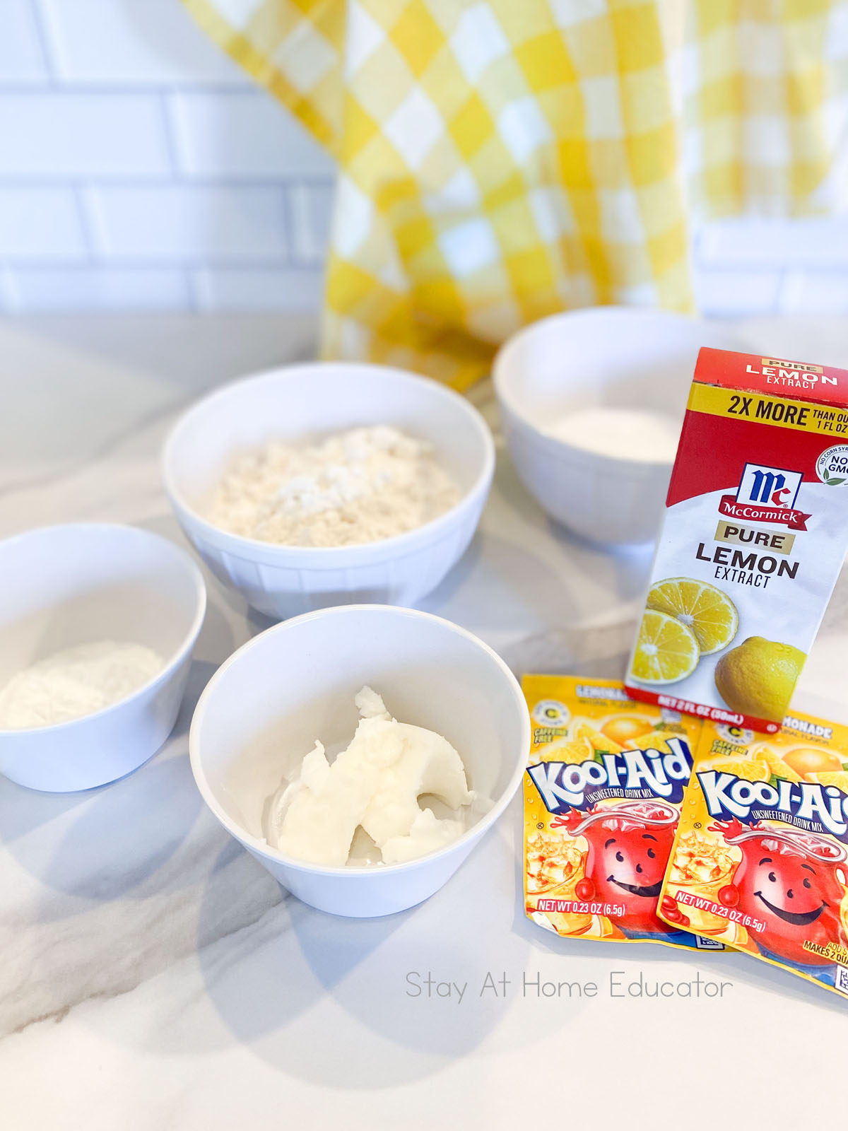 ingredients for ball of lemon playdough on parchment paper using classic cooked playdough recipe | lemonade playdough with lemon juice