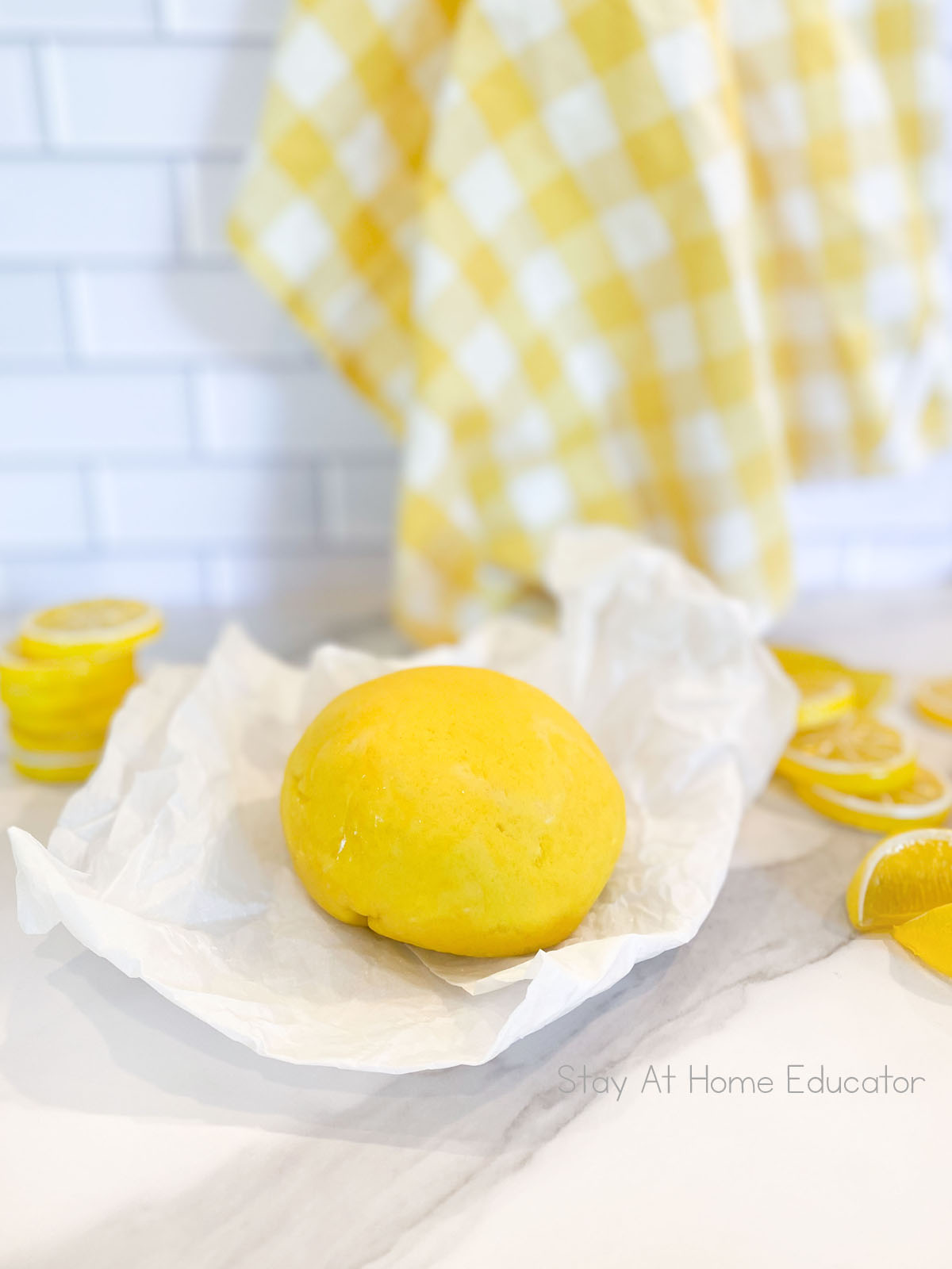 ingredients for ball of lemon playdough on parchment paper using classic cooked playdough recipe | lemonade playdough with lemon juice